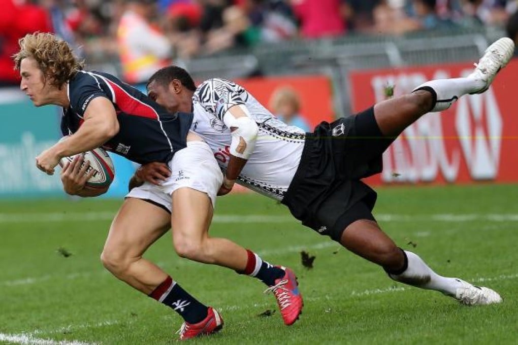Tom McQueen is stopped in his tracks by Samisoni Viriviri as Hong Kong found it hard going against the mighty Fijians. Photo: K.Y. Cheng