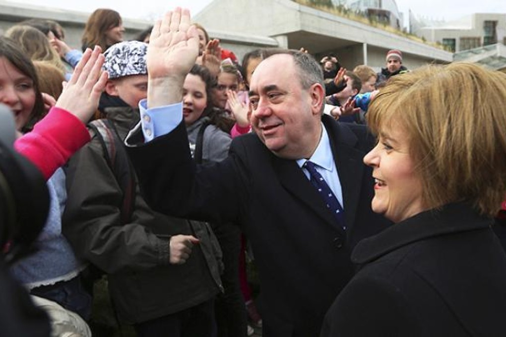 Scotland's First Minister and leader of the Scottish National Party Salmond and his deputy leader Nicola Sturgeon chat to schoolchildren outside the Scottish Parliament in Edinburgh. Photo: Reuters