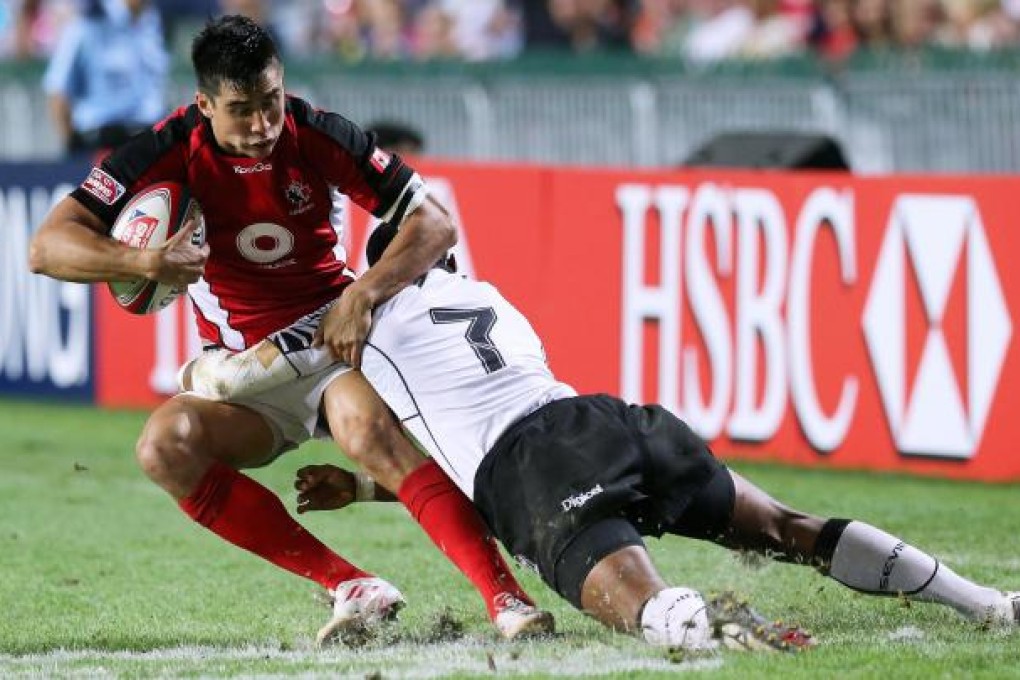 Canada's Sean Duke is tackled by Samisoni Viriviri during Fiji's 26-5 victory. Both teams were in the same pool as Hong Kong, with the hosts losing all their matches including their final one to Spain. Photo: K.Y. Cheng