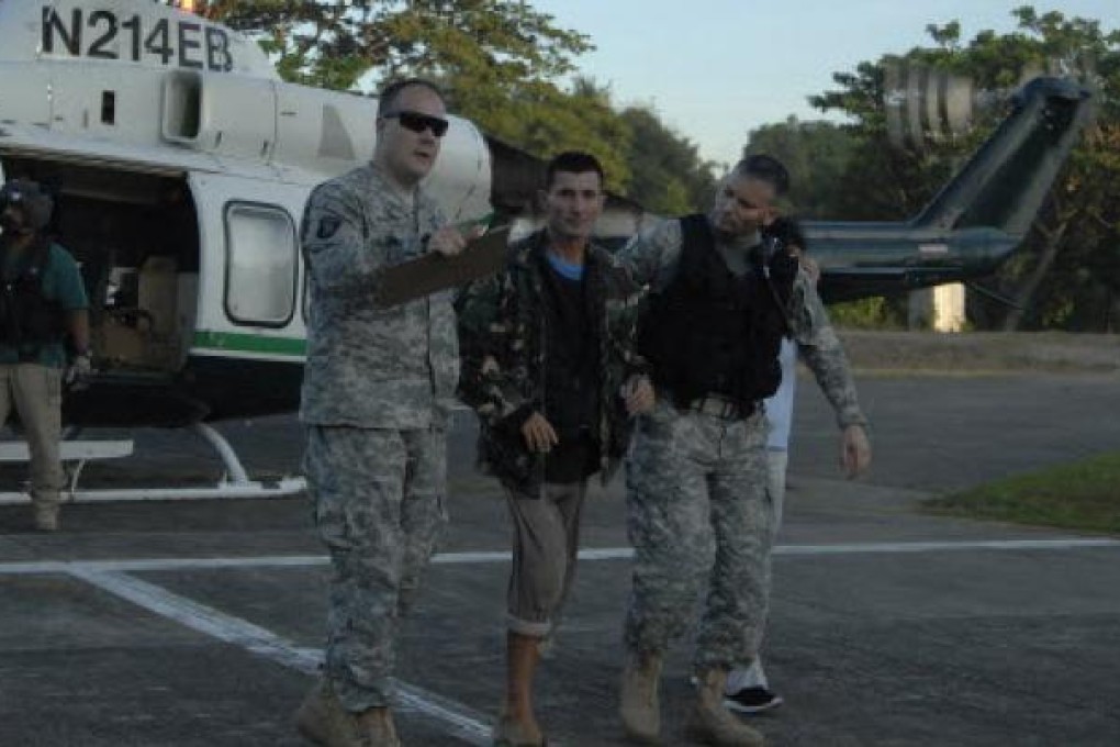 US servicemen assist freed Australian Warren Richard Rodwell after he gets off a helicopter inside a military camp in Zamboanga City, Philippines. Photo: Reuters