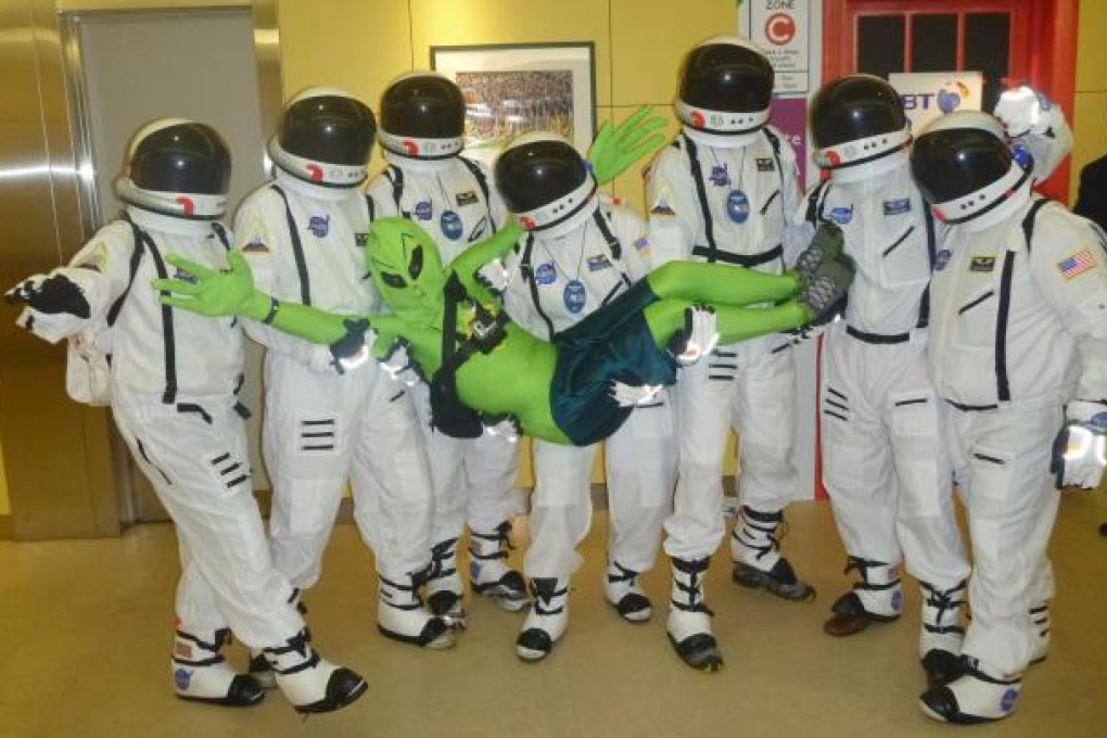 Stephen Gore and his team of astronauts keep a tight hold on a captured alien.