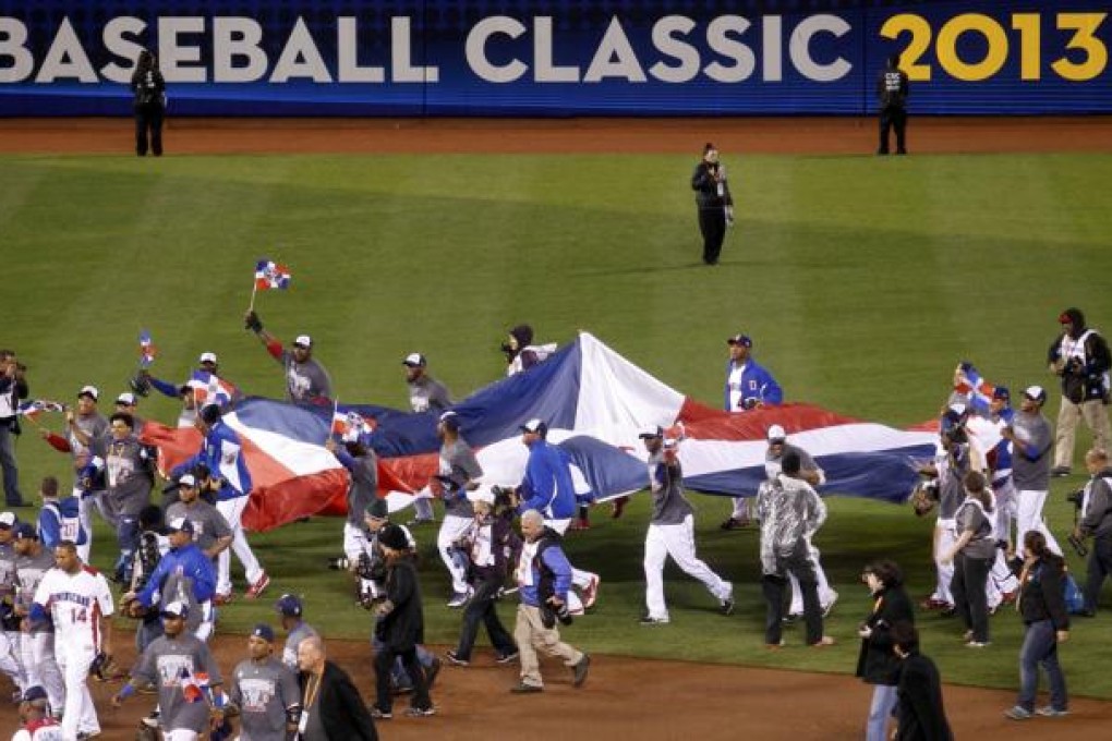 Dominican Republic players carry their flag around the field after defeating Puerto Rico in their World Baseball Classic final in San Francisco. Photo: Reuters