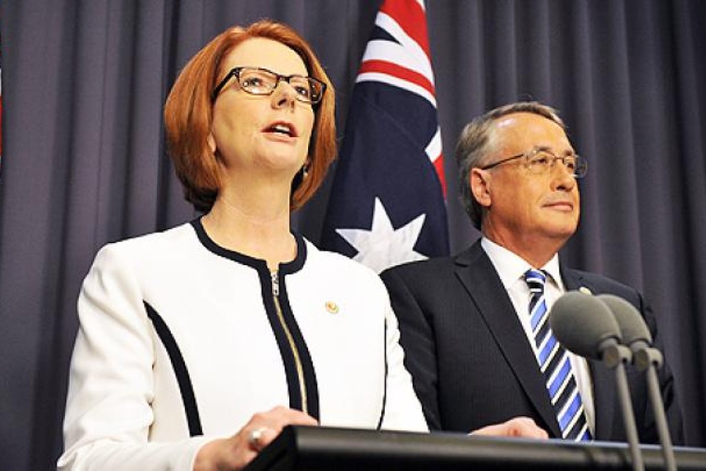 Australian Prime Minister Julia Gillard (left) along with Deputy Prime Minister Wayne Swan addresses a press conference in Canberra. Photo: AFP