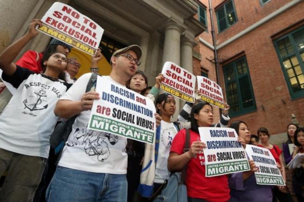 Eman Villanueva (second left), spokesman for the Asian Migrants' Coordinating Body, with protesters yesterday. Photo: Sam Tsang