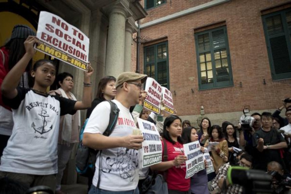 Labor rights group Asian Migrants Coordinating Body addresses the media after the Court of Final Appeal ruled that foreign maids were not eligible to seek permanent residency in a legal battle that has split the city. Photo: AFP