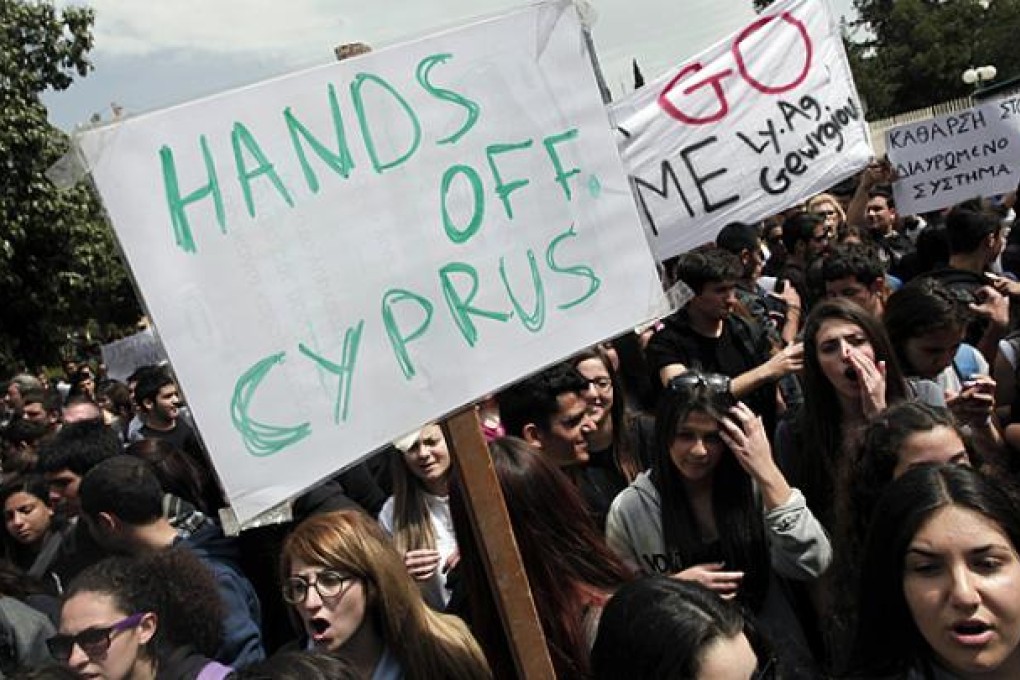 Cypriot students shout slogans during a protest against the bailout package outside the presidential palace in capital Nicosia. Photo: AP