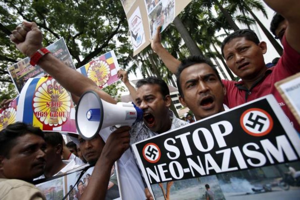 Myanmar Muslims living in Malaysia hold placards as they shout slogans during a protest against ethnic unrest between Buddhists and Muslim in Meikhtila, Myanmar. Photo: AP