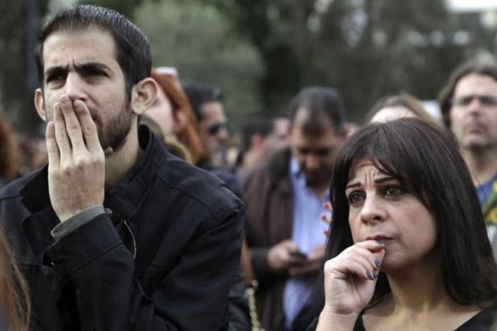 The Governor of Central Bank of Cyprus Panicos Demetriades said in a press conference "a superhuman effort" is being made for the banks to open on March 28 and he also confirmed that a so-called haircut or levy on deposits over 100,000 euros ($130,000) at the stricken Bank of Cyprus and Laiki Bank would be 'around 40 percent.' Photo: AFP