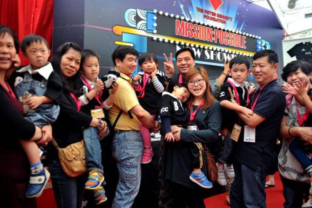 Children with infantile autism and other diseases pose for photos with their parents during the "Mission Possible" charity event in Hong Kong. Photo: Xinhua