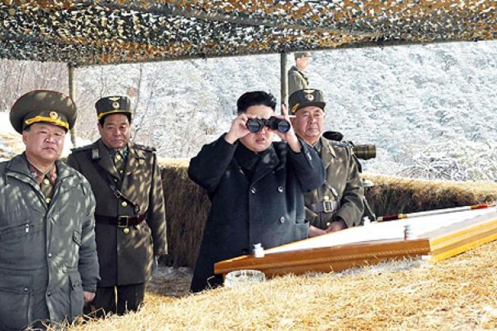 North Korean leader Kim Jong-un (second right) overseas a live fire drill using self-propelled drones at an undisclosed location in North Korea. Photo: AFP