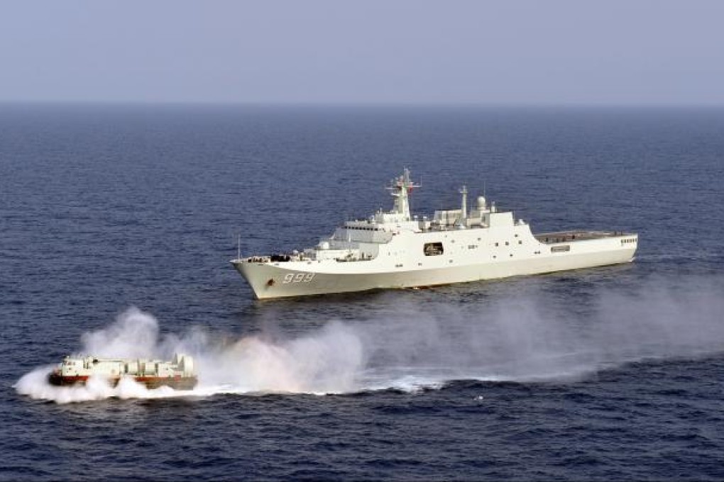 Chinese Navy's amphibious landing ship Jinggangshan is seen during a training with a hovercraft in waters near Hainan Province on March 20, 2013. Photo: Xinhua