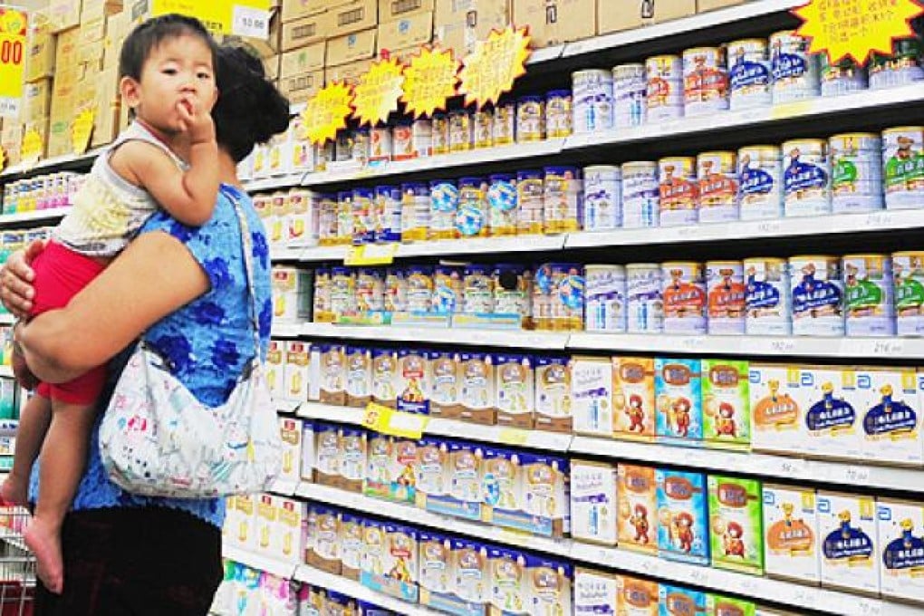 A Chinese woman selects milk powder for her child at a supermarket in Beijing. Photo: AFP