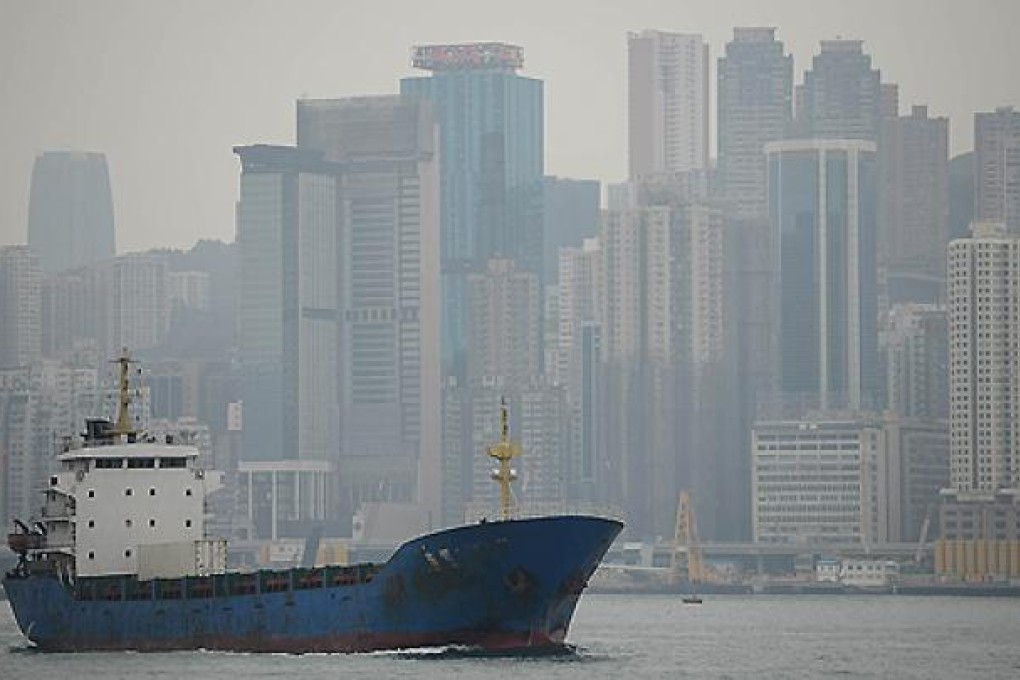 A haze of pollution shrouds Victoria Harbour and the Hong Kong skyline in January. Photo: AFP
