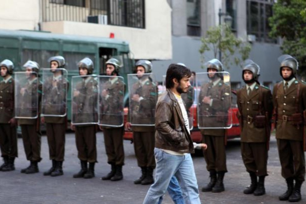 Advertising executive René Saavedra (played by Gael Garcia Bernal) walks past ranks of security personnel.