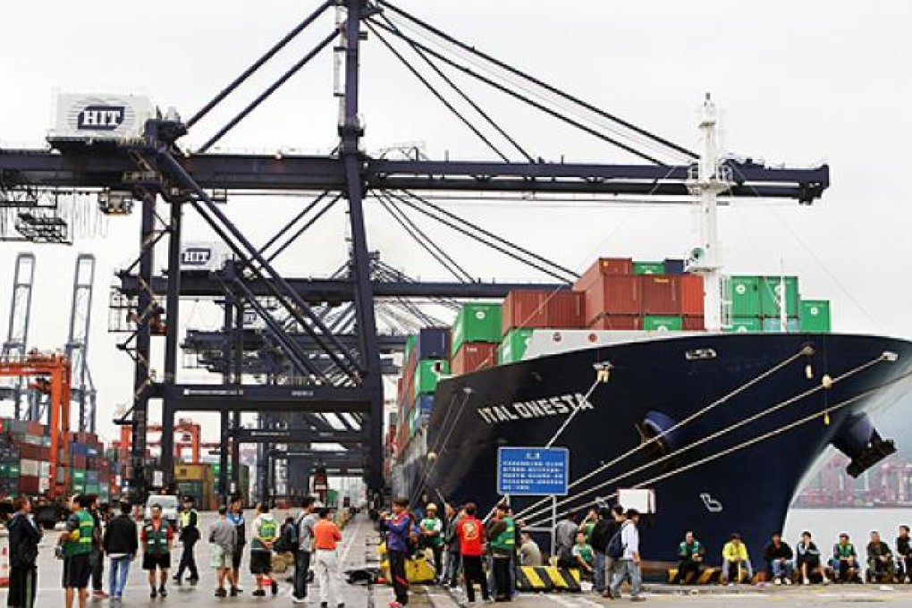 Dock workers block the road at Terminal No 6 at the Kwai Tsing Container Terminals on Friday, the second day of their protest for a pay rise. Photo: Edward Wong