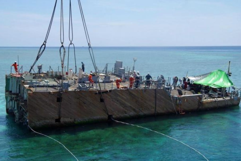 The midsection of USS Guardian is lifted from the reef. Photo: EPA