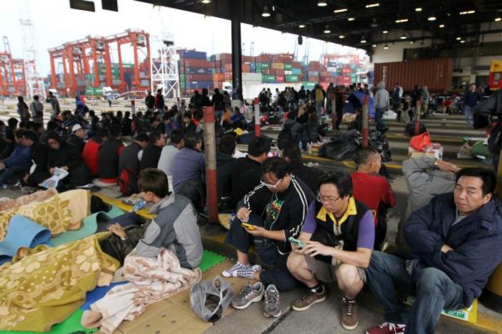 Workers on strike at Kwai Tsing terminal yesterday. They are demanding a 17 per cent pay rise and say their salaries have been raised just once in 15 years. Photo: Edward Wong
