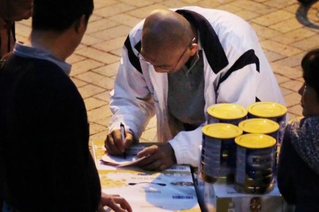 A parallel trader with tins of milk formula. Photo: Nora Tam