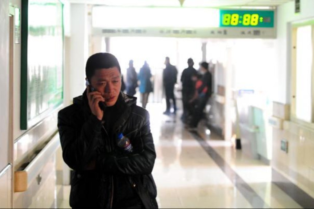 A relative of an injured miner in a hospital. Photo: Xinhua