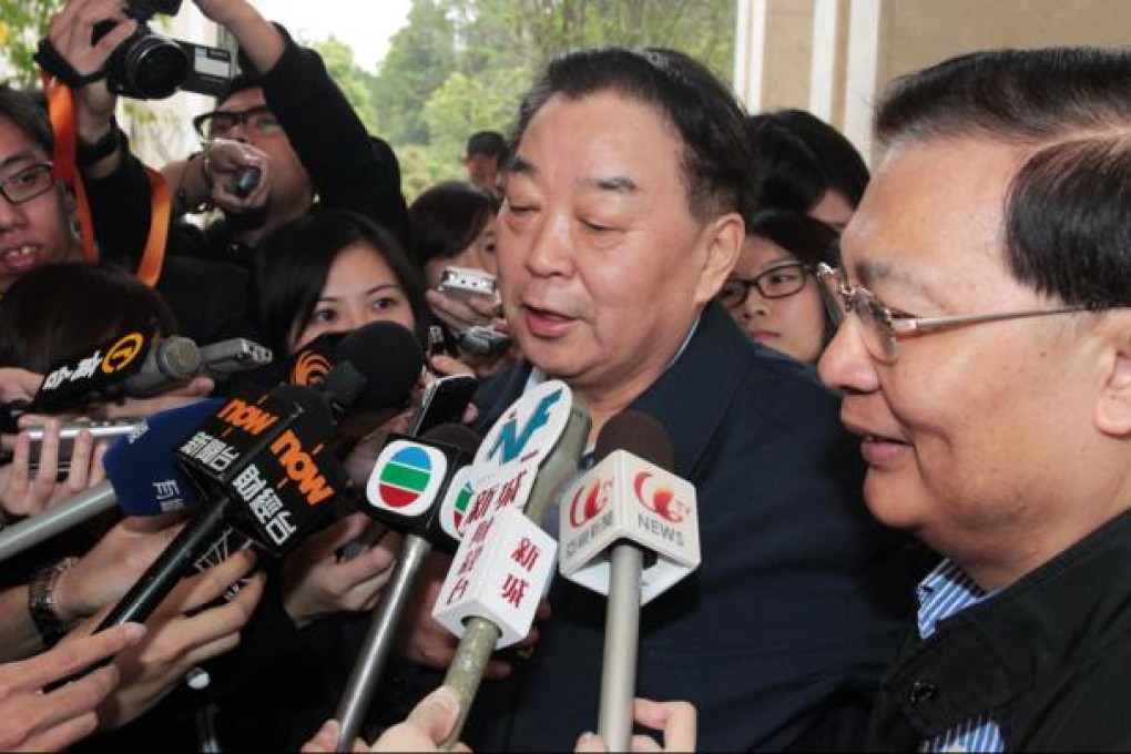 Qiao Xiaoyang (centre) speaks to reporters in Shenzhen. Photo: SCMP