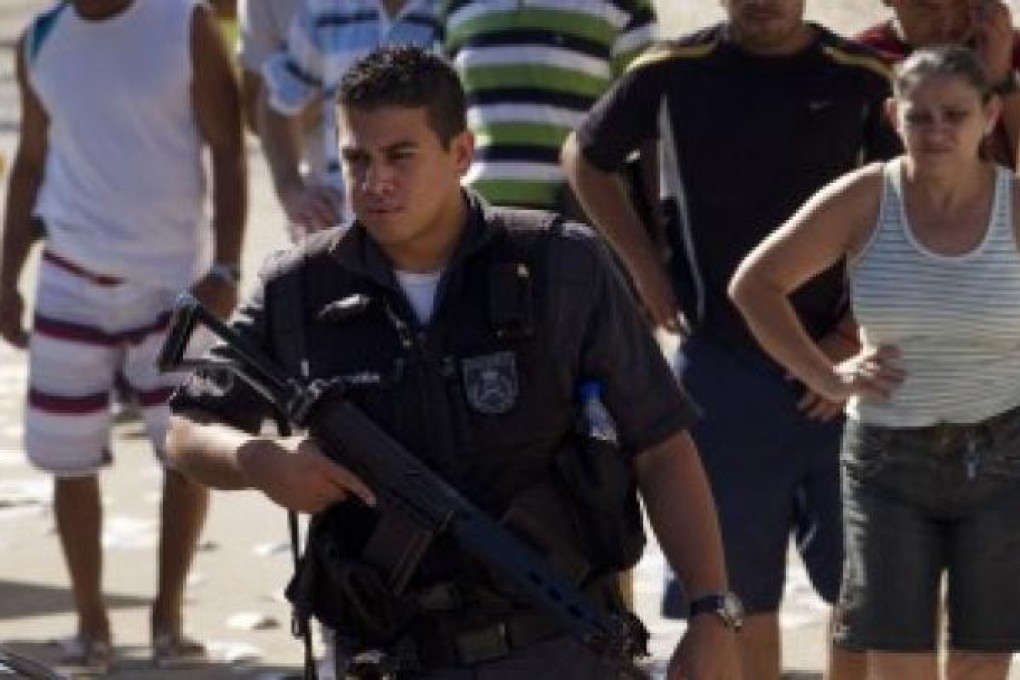 A heavily-armed Brazilian policeman on duty in San Paolo. Photo: AP