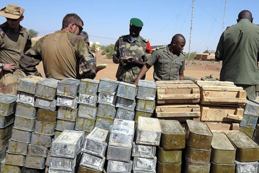 French and Malian soldiers stand next to cases of ammunition in Gao, northern Mali. Photo: AFP