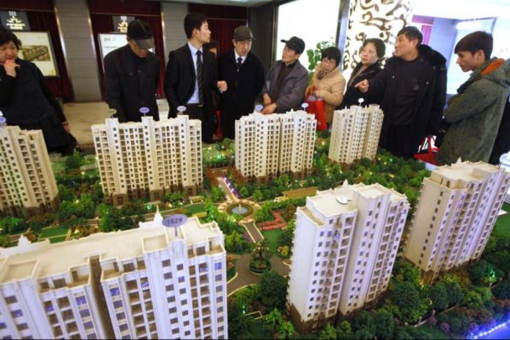 People visit a real estate stand during the 2013 Spring Real Estate exhibition in Shanghai . Photo: Reuters