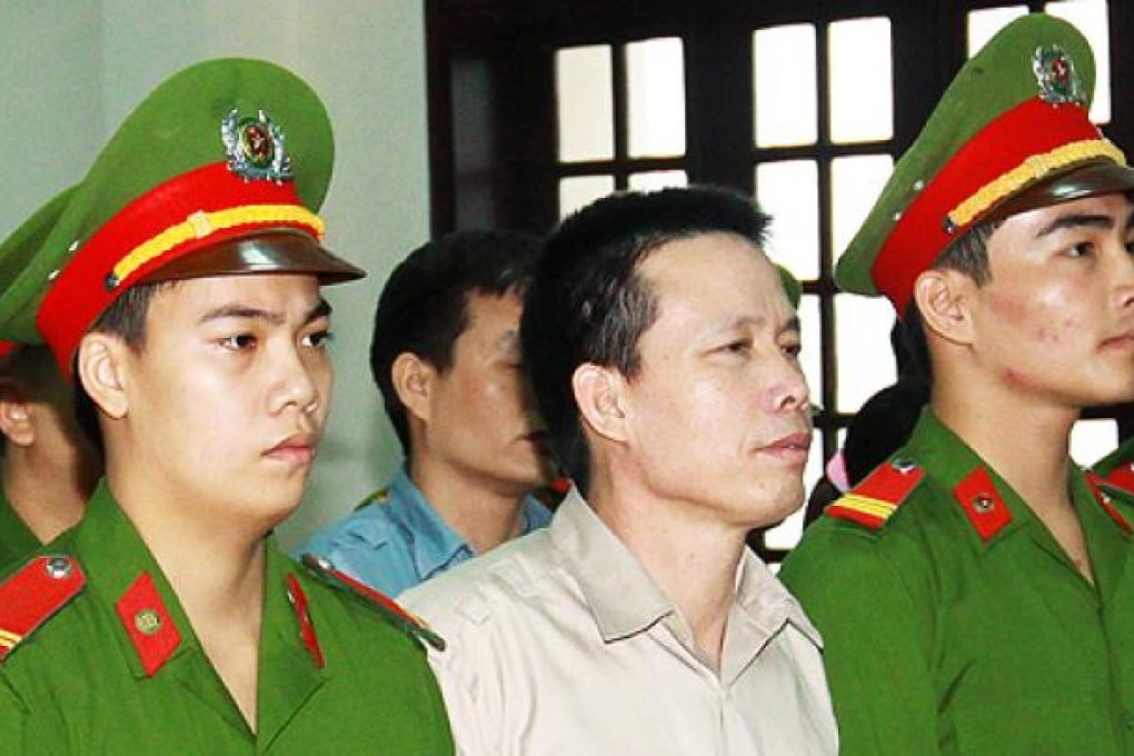 Fisher farmer Doan Van Vuon (centre) stands trial at a local People's Court House in Hai Phong on Tuesday. Photo: AFP