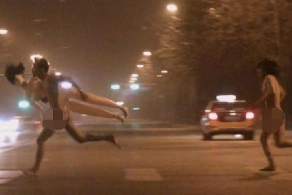 A man and woman running naked on a street in Beijing. Photo: Weibo/SCMP pictures