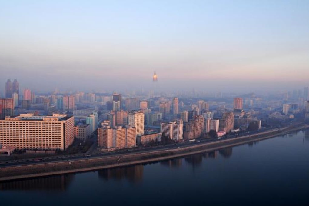 Morning sunshine reflects off the tip of the Ryugyong Hotel, which towers over the Pyongyang skyline. Photos: Red Door News Hong Kong; Michal Koza