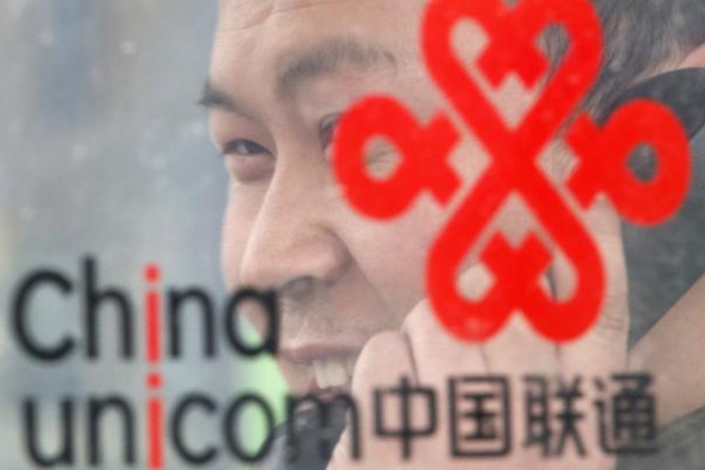 A man uses a China Unicom public telephone in Beijing. Photo: Reuters