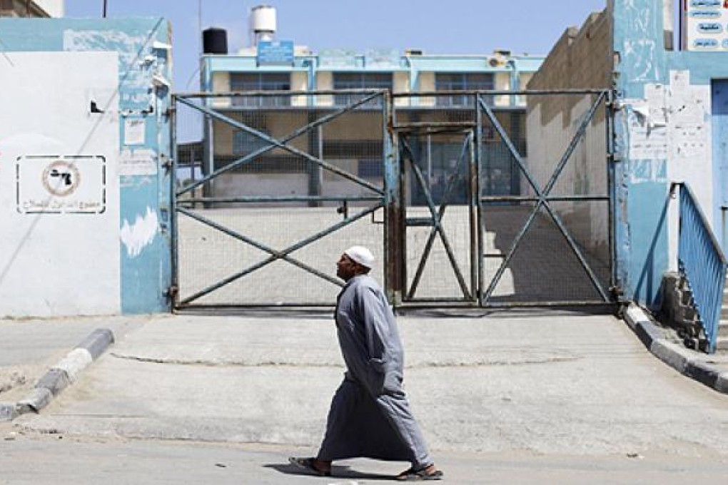 A Palestinian man walks past United Nations food distribution center in Khan Younis refugee camp in the southern Gaza Strip. Photo: Reuters