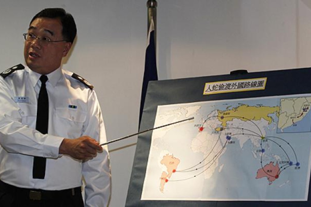 Hong Kong Immigration Department Assistant Director William Fung speaks beside a map showing the routes a human smuggling syndicate took during a news conference, on Friday. Photo Reuters