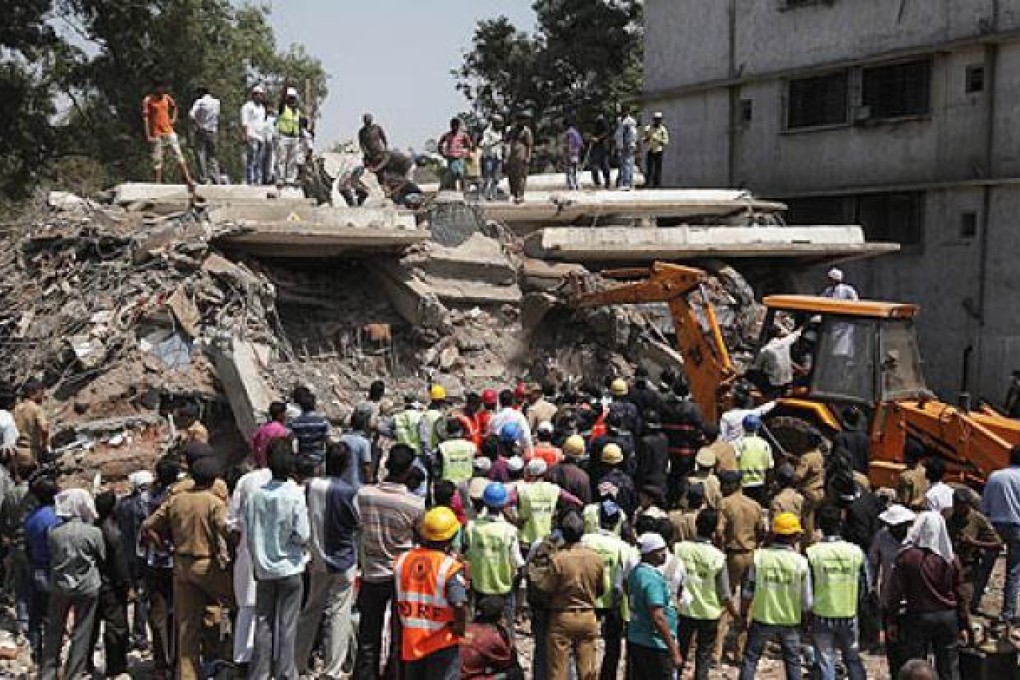 Rescuers work at an unauthorised eight-storey building, which was under construction, after it collapsed on the outskirts of Mumbai, on Friday. Photo: EPA
