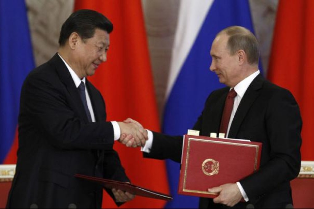 Russia's President Vladimir Putin (right) exchanges documents with Xi Jinping during a signing ceremony at the Kremlin in Moscow. Photo: Reuters