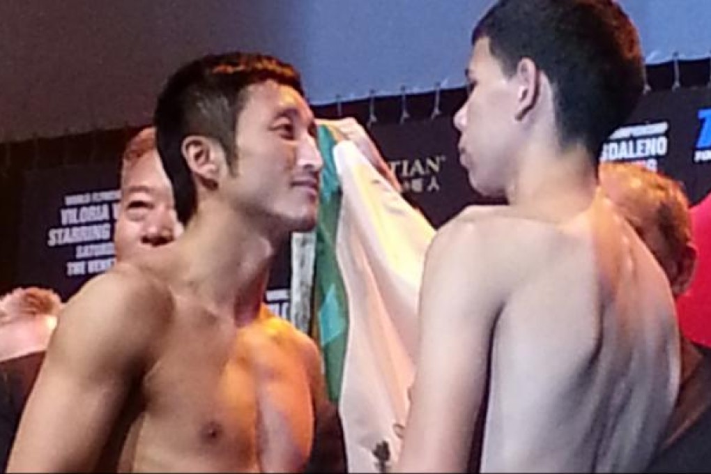 China's Zou Shiming with opponent Eleazar Valenzuela at yesterday's weigh-in for "Fists of Gold" at the Venetian. Photo: Unus Alladin