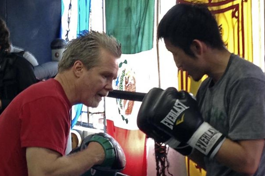 Chinese boxer Zou Shiming (right) spars with trainer Freddie Roach at Roach's Wild Card gym in Los Angeles. Photo: AP