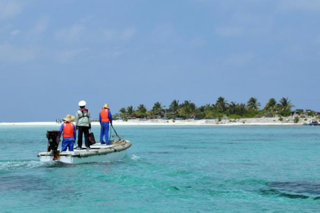 A China Marine Surveillance worker heads to Woody Island, Sansha city, Hainan. Island tours will start this month, but visitors cannot stay overnight. Photo: Xinhua