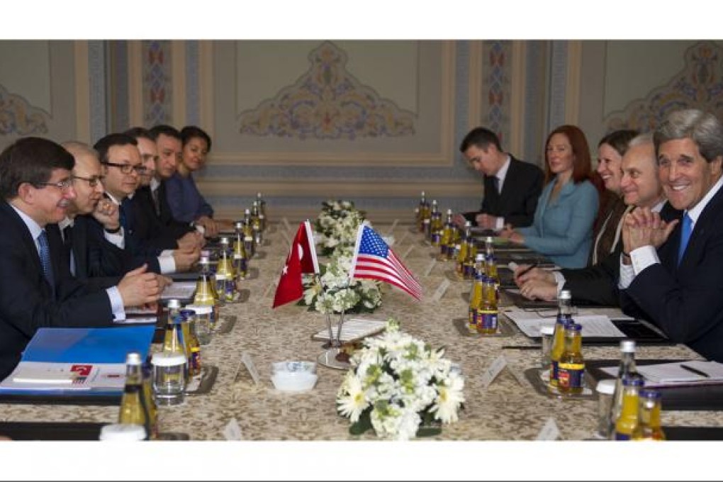 Turkish Foreign Minister Ahmet Davutoglu (left) and US Secretary of State John Kerry (right) meet in Istanbul yesterday. Photo: AFP