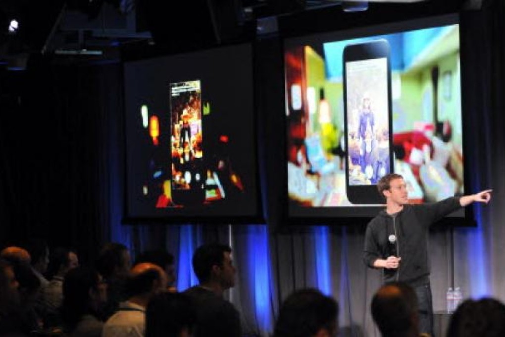 Facebook chief executive Mark Zuckerberg introduces a new smartphone at company headquarters. Photo: AFP