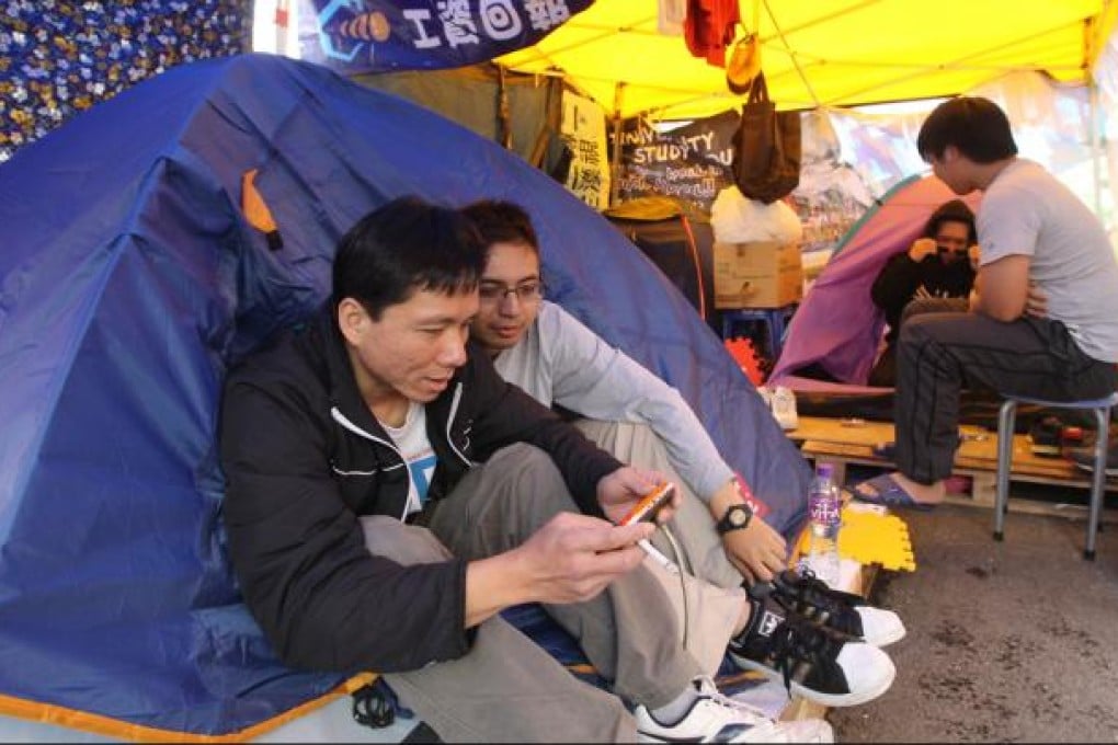 Dock workers occupy a road outside Kwai Chung Container Terminal on their strike demanding better wages and working conditions. Photo: Edward Wong