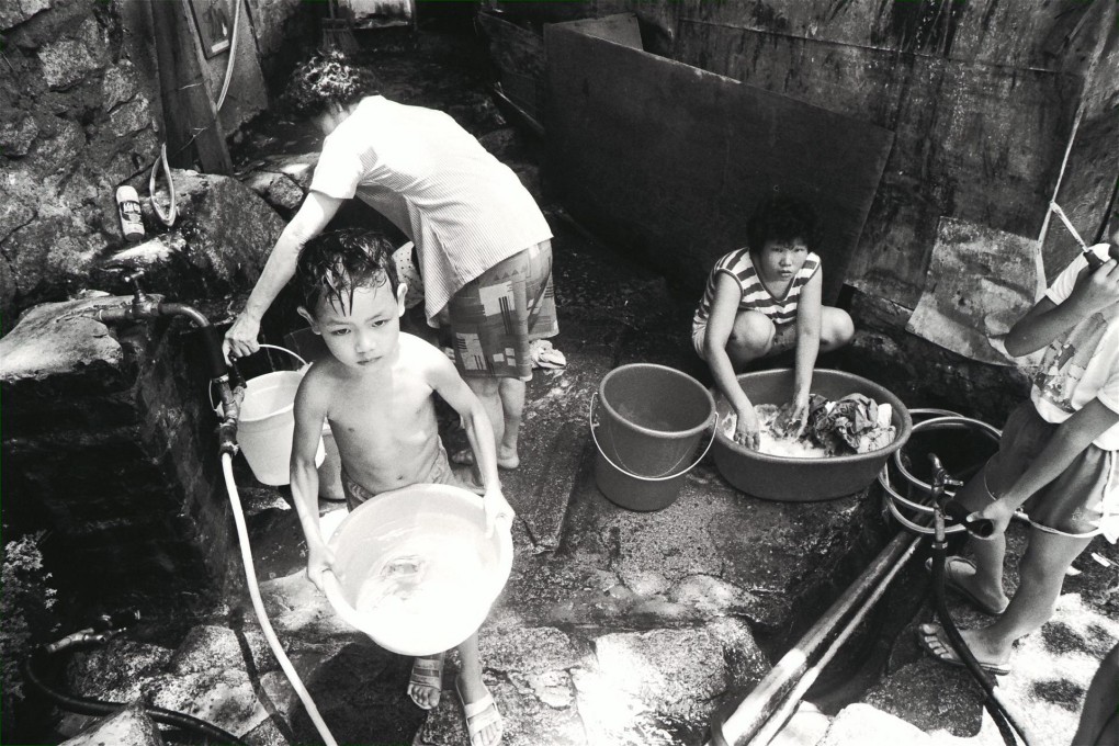 Squatters in 1986 wash clothes and bathe outdoors in the absence of bathrooms in their makeshift huts. Photos: SCMP