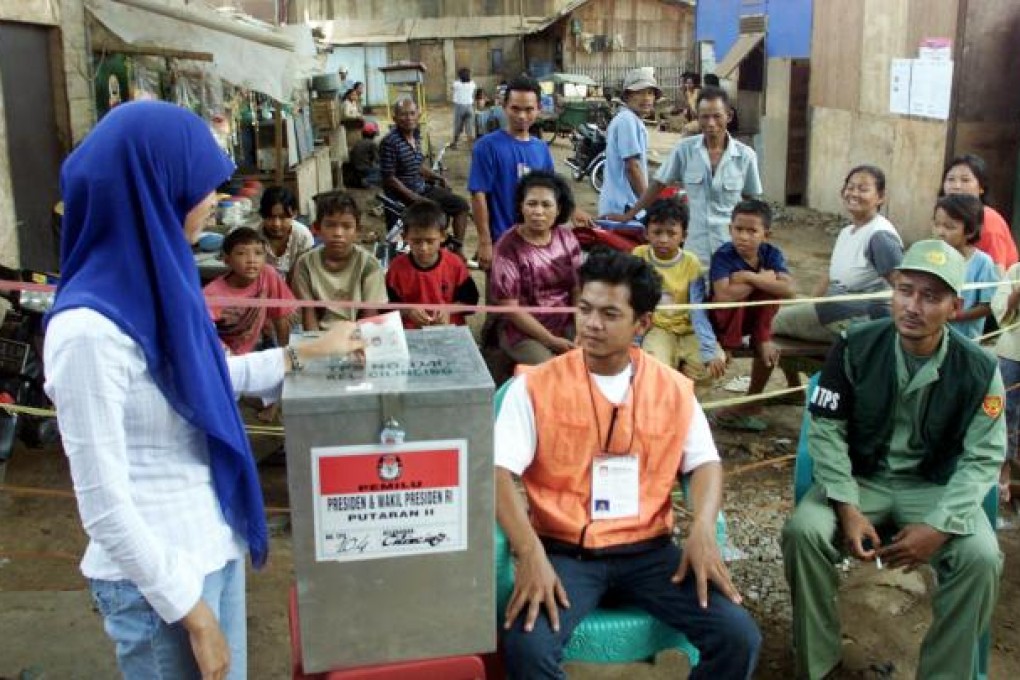 A woman casts her ballot in suburban Jakarta. Photo: AP