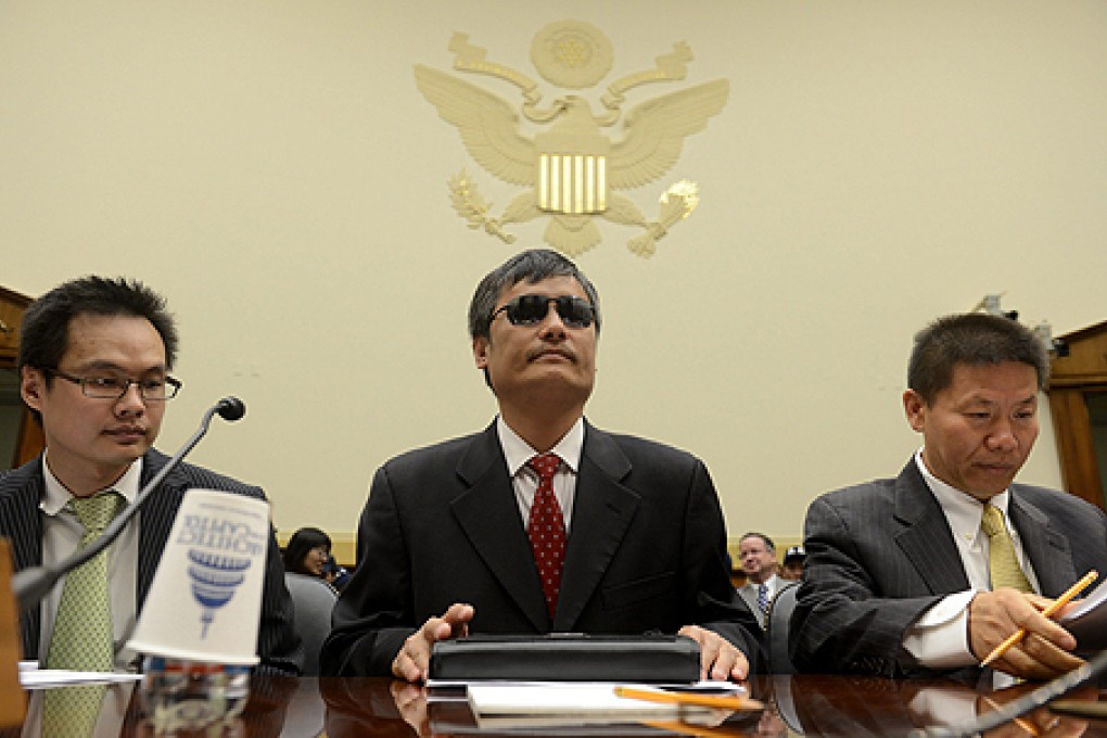 Chinese dissident Chen Guangcheng (centre) appears before the US House Foreign Affairs Committee. Photo: EPA