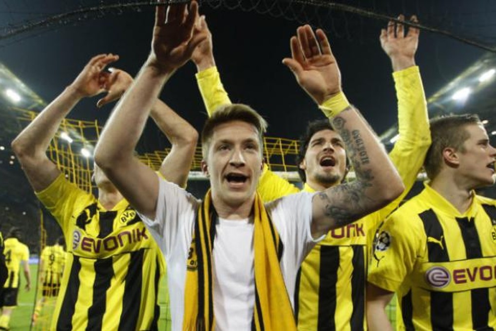 Borussia Dortmund's Marco Reus (C) and team mates celebrate after defeating Malaga to win the Champions League quarter-final second leg soccer match, in the western German city of Dortmund. Photo: Reuters.