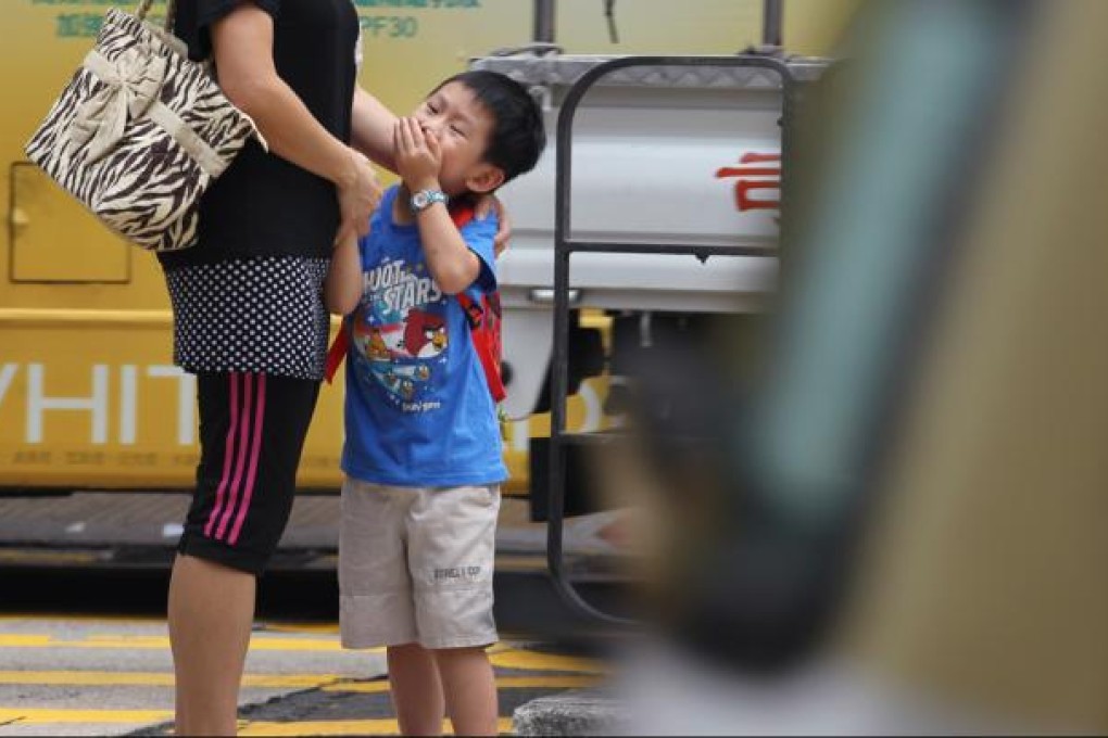 People cover their noses on a street in Mong Kok. Photo: Nora Tam