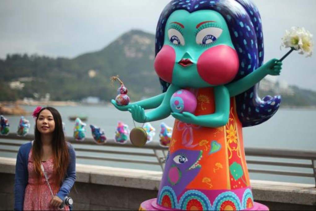 Artist Kiwi Liu with The Goddess of Sharks at yesterday's opening ceremony of the International Ocean Film Festival. Photo: Sam Tsang