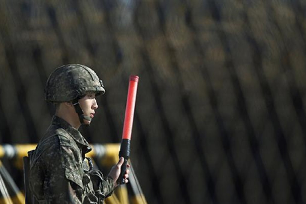 A South Korean soldier directs traffic at a checkpoint on the Grand Unification Bridge. Photo: Reuters