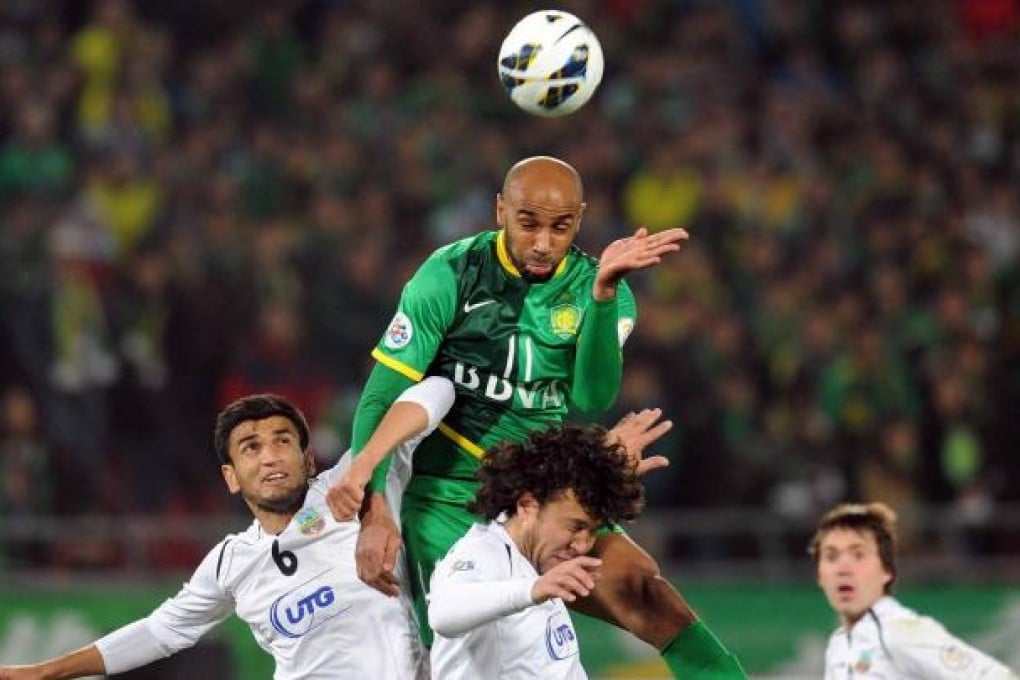 Oumar Kanoute of Beijing Guoan heads the ball during their defeat to Bunyodkor in Beijing last night. Photo: Xinhua