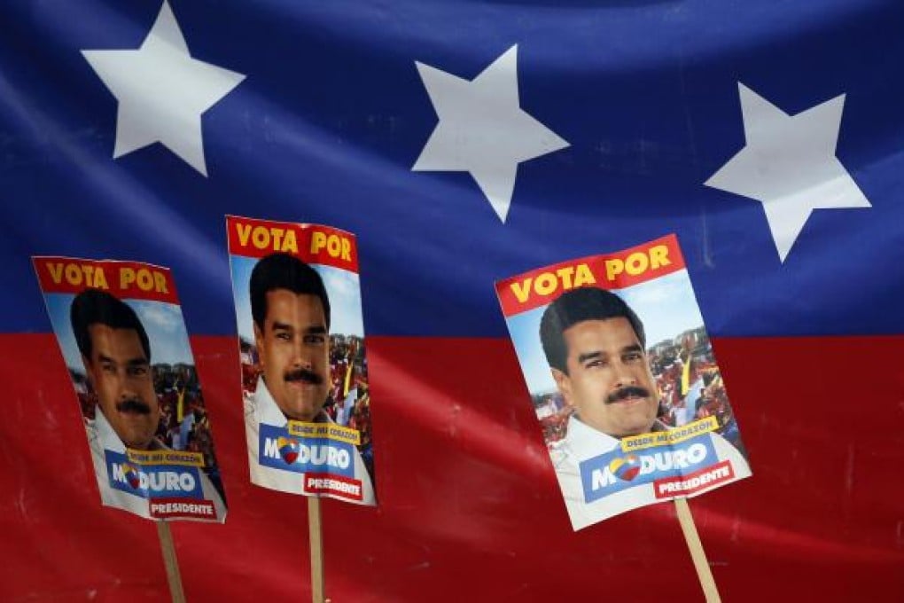 Supporters hold up placards of Nicolas Maduro, the man they want to succeed Hugo Chavez, during his closing rally in Caracas.Photo: AP